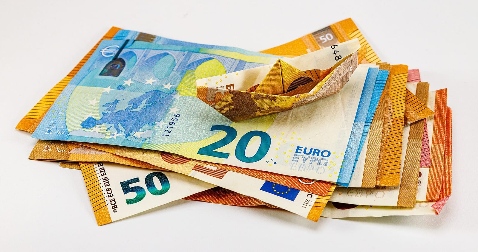 Plain euro banknotes, one of which is folded as a paper boat Object: Euro banknote Title Euro banknote Depicts Spijkenisse's euro-bridges Object: Paper boat Title Paper boat Made from material paper